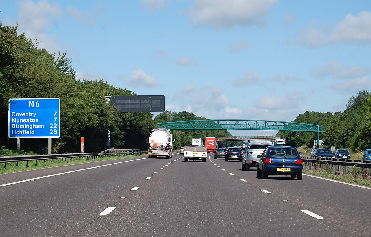 An M6 motorway sign in England showing the distance in miles to Coventry, Nuneaton, Birmingham and Lichfield